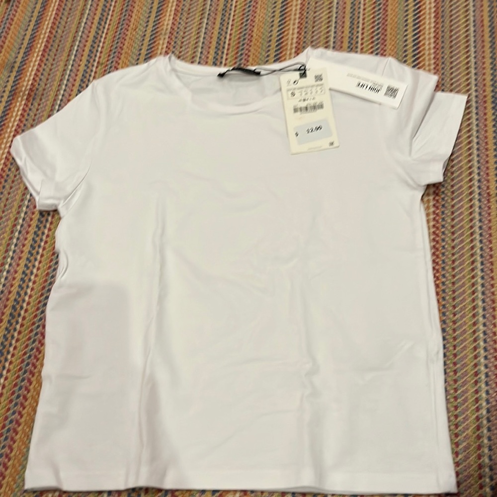 This is a Zara small T-shirt. It is white it has never been worn before (tag)
